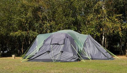 Navy blue and green large family tent in camping field , on the edge of plain in the New Forest National Park , United Kingdom . - 431768685
