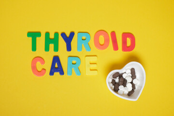 inscription thyroid care on yellow backgroundc top view