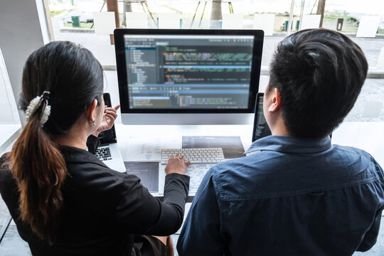 Team of developer programmer working on project in software development computer in IT company office, Writing codes and data code website and coding database technologies to find problem solution