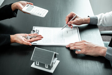 Estate agent are presenting home loan and sending keys to client after signing contract to rental house Insurance with approved property form