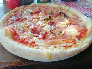 Pizza with jam, mushrooms, cheese and olives on plate