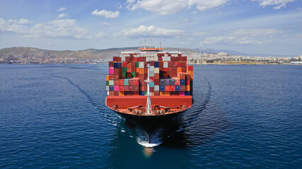 Aerial drone photo of huge container carrier tanker ship cruising deep blue open ocean sea