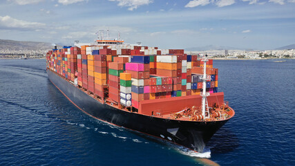 Aerial drone photo of huge container carrier tanker ship cruising deep blue open ocean sea