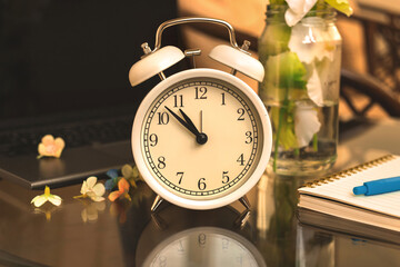 Alarm clock morning background in warm tones, cozy workplace concept