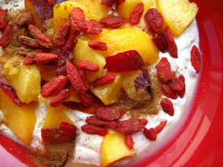 Healthy breakfast bowl with peach and goji berries