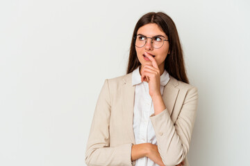 Young business caucasian woman isolated on white background relaxed thinking about something looking at a copy space.