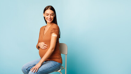 Pregnant Woman Vaccinated Against Coronavirus Sitting On Blue Background, Panorama