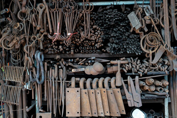 A steel hook hangs among rusty iron chains