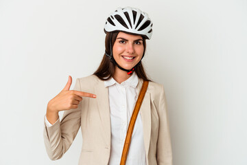 Young caucasian woman riding a bicycle to work isolated on white background person pointing by hand to a shirt copy space, proud and confident
