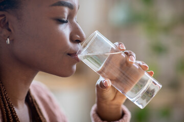 Body Hydration Concept. Closeup Of Black Millennial Female Enjoying Mineral Water