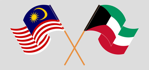 Crossed and waving flags of Malaysia and Kuwait