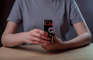 Photographer hands holding old antique vintage film camera. Retro photo lens.