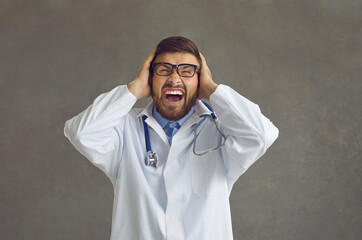 Vexed angry mad crazy stressed frustrated doctor in white lab coat and stethoscope shouting loudly...