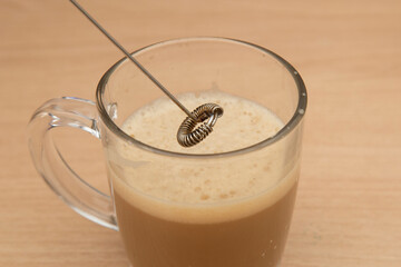 Making cappuccino coffee with a mixer at home.