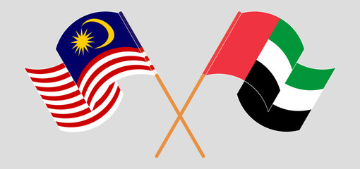 Crossed and waving flags of Malaysia and the United Arab Emirates