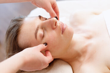 Obraz na płótnie Canvas woman on facial massage at a beautician