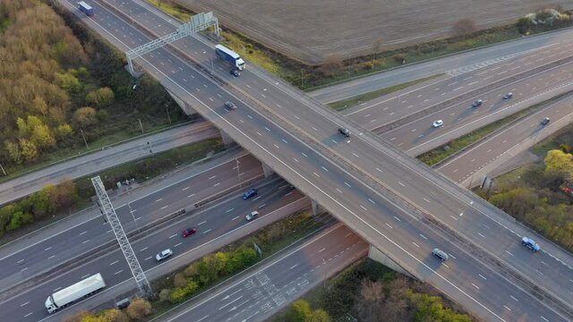 Vehicles Driving on a Motorway at Sunset Using Bridge Infrastructure