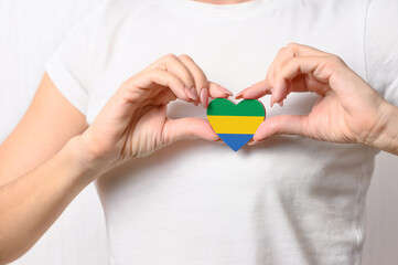 Flag of Gabon in the shape of a heart in the hands of a girl. Love Gabon. Respect for the people of...