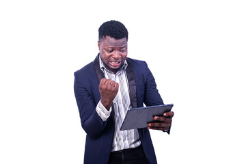 handsome young businessman using a digital tablet making the winning gesture.
