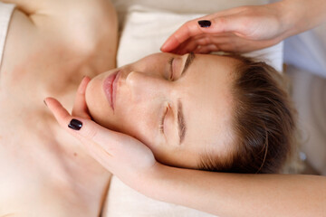 Obraz na płótnie Canvas woman's face massage close-up anti-ageing procedures