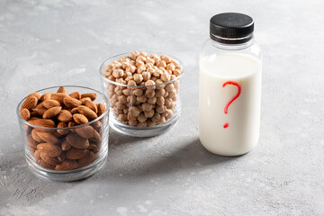 Different vegan milks on light background. Chickpea or almond milk. Substitute for dairy milk.