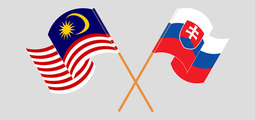 Crossed and waving flags of Malaysia and Slovakia