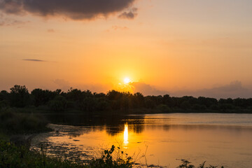 Fototapeta na wymiar Yellow sunset over the lake in Pelican Park, Florida