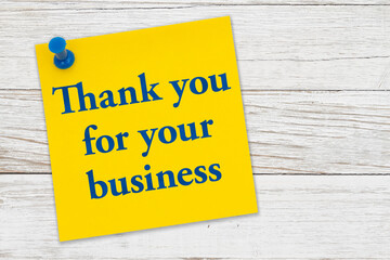 Thank you for your business message on a yellow sticky note paper with pushpin