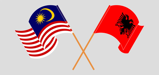 Crossed and waving flags of Malaysia and Albania