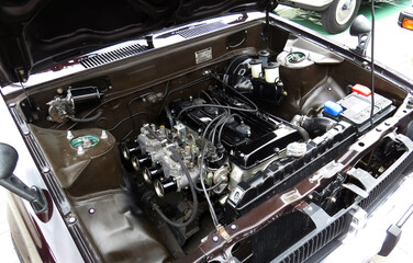 car under the hood close-up, view of a modern engine, other mechanical and electrical parts 