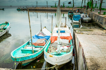 Fototapeta na wymiar Two colorful Mexican panga fishing boats docked in the harbor along the Melecon, Campeche, Mexico.