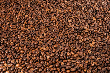 Coffee beans. Coffee beans are spread out on the surface.