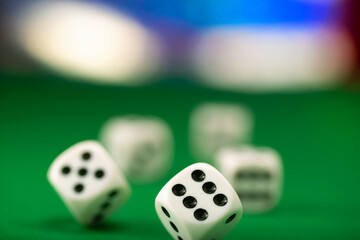 White dice on green felt table close up