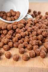 Crunchy chocolate cereal with white cup. Textured flakes balls