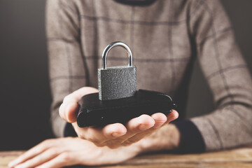 lock on a black wallet. money safety concept
