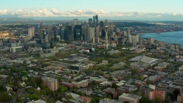 Drone Flying over Queen Anne Neighborhood Going Towards Downtown Seattle Clouds in View Late Afternoon