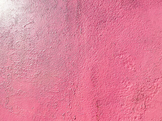 Fototapeta premium Red pinkish texture of a metallic iron old wall painted with cracks and abrasions. The background. Texture