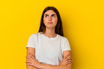 Fototapeta premium Young caucasian woman isolated on yellow background tired of a repetitive task.