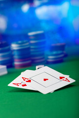 Two aces and stack of Casino Chips in background