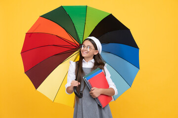 kid in beret with rainbow umbrella. autumn season. rainy weather forecast. back to school.