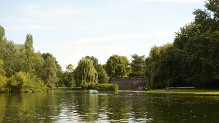 Fototapeta premium small lake with beautiful botany on which pedal boats go