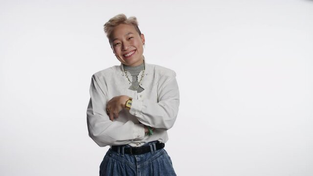Beautiful Asian person cracks up with infectious laugh
