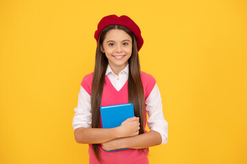 study exam. cheerful kid in beret ready to study. smiling child with book.