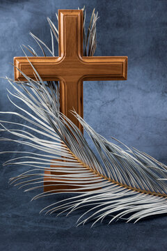 Catholic Cross with palm leaf. Ash Wednesday, Lent season, Holy Week, Good Friday and Palm Sunday concept. Copy space.