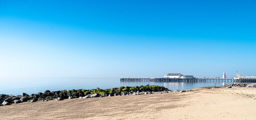 Clacton Beach and Pier from the North side panoramic view in springtime sunlight