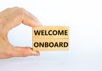 Welcome onboard symbol. Wooden blocks with words 'Welcome onboard' on beautiful white background. Businessman hand. Business and welcome onboard concept. Copy space.
