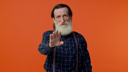 Elderly bearded gray-haired man say no hold palm folded crossed hands in stop gesture, warning of...