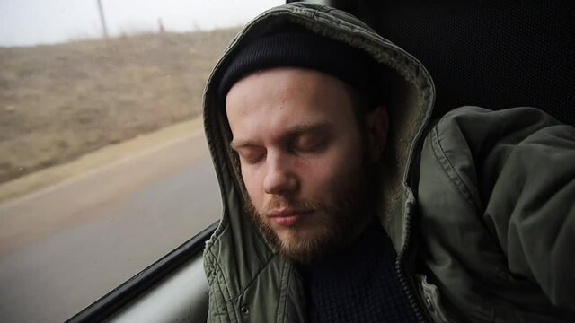 man sleeps in a driving car, on a trip