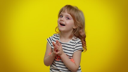 Villain idea. Sneaky playful blonde child girl conspiring scheming, thinking over tricky plan with cunning expression, pondering revenge or evil joke prank. Teen kid children on yellow background