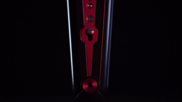 Violet curling iron for hair icon isolated on black background. Red light illuminates countours and buttons of Hair straightener icon.